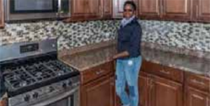 Keona Tate enjoys her new kitchen in the home she rehabilitated as an American Dream homeowner in Chicago. (U.S. Bank)